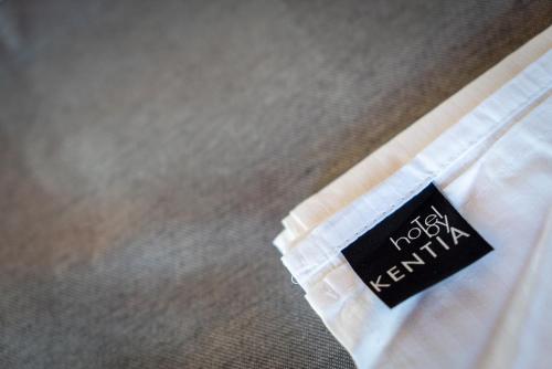 a black sign on the side of a white bed at Helene Eco Luxury Villa in Tsagarada