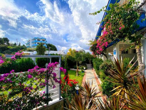 a garden with flowers on the side of a building at SCALA APARTS & STUDIOS - Rhodes in Afantou