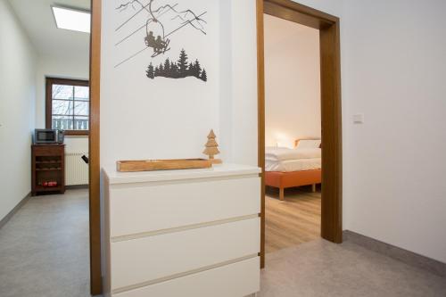 a room with a mirror and a dresser with a bedroom at Zur Postwiese 15, Neuastenberg-Winterberg in Winterberg