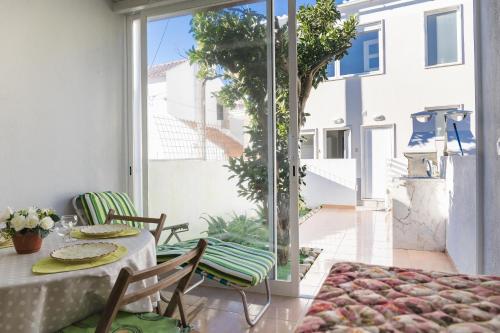 a dining room with a table and chairs on a patio at 2 Bedroom house and Garden Lounge in Sintra