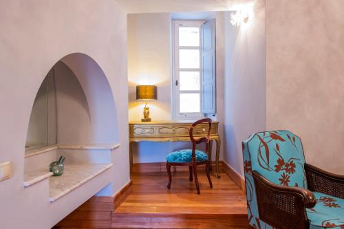 a room with a desk and a chair and a window at Villa Selena in Ermoupoli