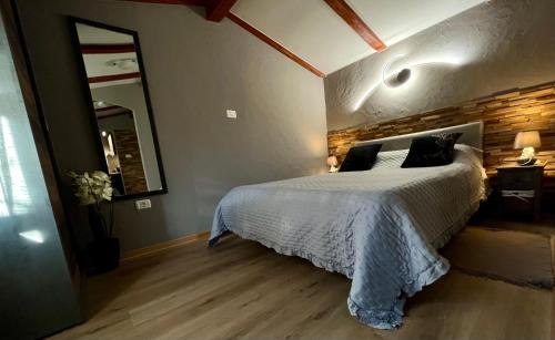 a bedroom with a bed and a brick wall at Apartment Eos in Strunjan