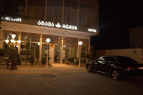 a car parked in front of a building at night at Hotel Agava in Tbilisi City