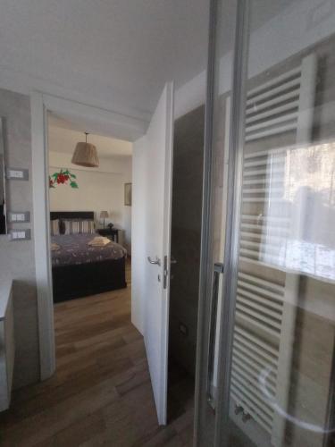 a room with a bedroom with a bed and a door at La Tana del Ghiro Locazione Turistica in Sedico