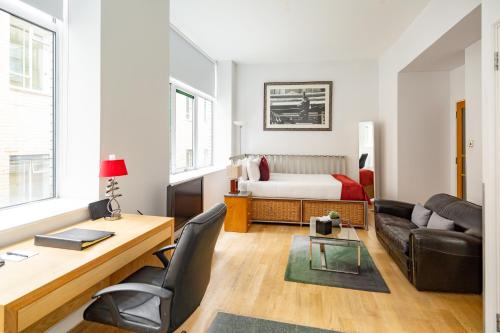 a living room with a desk and a bed at 196 Bishopsgate in London