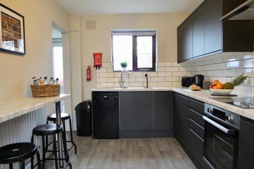 a kitchen with black cabinets and a counter top at Hambleton Road East in Catterick Camp