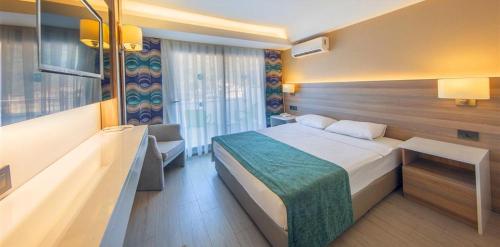 Ένα ή περισσότερα κρεβάτια σε δωμάτιο στο Idas Hotel