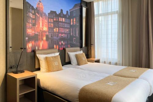 a hotel room with a large bed and a large window at XO Hotel Inner in Amsterdam