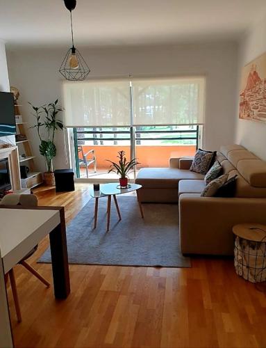 a living room with a couch and a table at Aroeira Lisbon Golf & Beach in Charneca