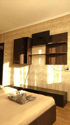a bedroom with a bed and some wooden cabinets at Проспект Незалежності 48 City Rooms in Bila Tserkva