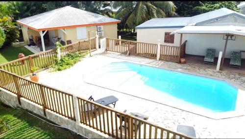 a large swimming pool next to a house at Domaine De Berard in Sainte-Anne