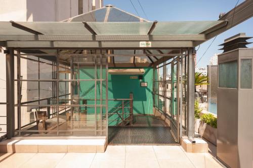 a building with a green door on a balcony at San Telmo Suites in Buenos Aires
