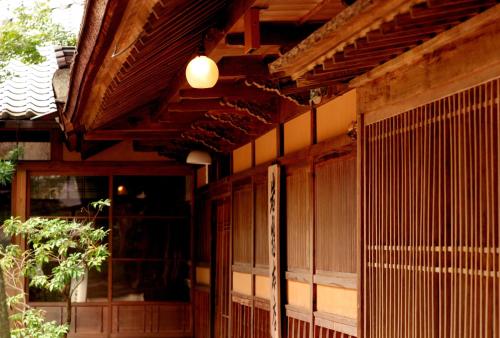 a building with a porch with a light on it at Iwaso in Miyajima