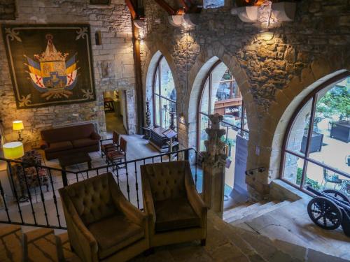 a room with two chairs in a building with windows at Parador de Hondarribia in Hondarribia