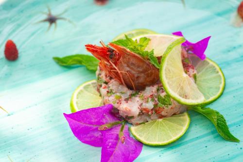 a seafood dish with a lobster and lime slices at Hotel Villa Bianca in Ischia
