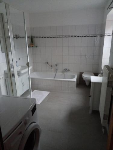 a bathroom with a tub and a toilet and a sink at Ferienhaus Jantzen in Süsel