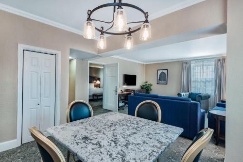 a dining room and living room with a table and chairs at The Americus Hotel, Trademark Collection by Wyndham in Allentown