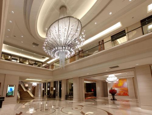 a large chandelier in a building with a lobby at The Okura Prestige Taipei in Taipei