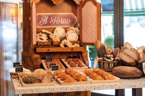 a bakery with different types of bread on a counter at Hotel Cipriani, A Belmond Hotel, Venice in Venice