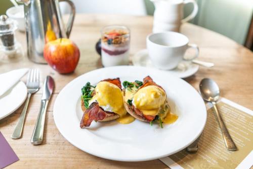 a white plate with breakfast food on a table at Brooks Guesthouse Bristol in Bristol