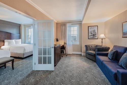 a hotel room with a bed and a couch at The Americus Hotel, Trademark Collection by Wyndham in Allentown