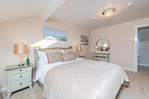 a white bedroom with a bed and a window at MOUNT BARKER in Swords