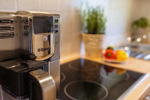 a coffee maker sitting on top of a stove in a kitchen at Ferienwohnung Hörndlwand Ruhpolding in Ruhpolding