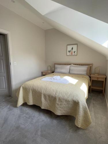 a bedroom with a large bed in a attic at Bournemouth cottage 6mins from beach, free parking in Bournemouth
