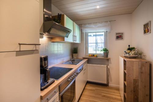 a small kitchen with a sink and a stove at Ferienwohnung Hörndlwand Ruhpolding in Ruhpolding