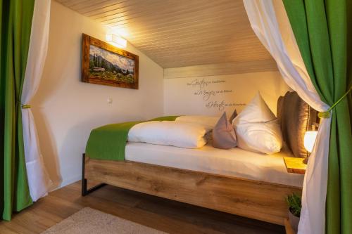a bedroom with a bed with a wooden frame at Ferienwohnung Hörndlwand Ruhpolding in Ruhpolding