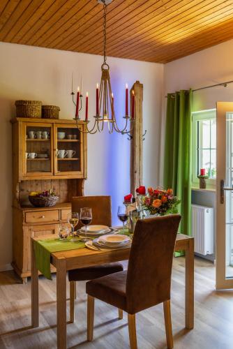 a dining room with a table and a chandelier at Ferienwohnung Hörndlwand Ruhpolding in Ruhpolding