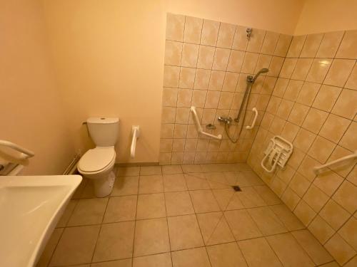 a bathroom with a shower and a toilet and a tub at Logis - Hôtel et Restaurant Le Sofhotel in Forges-les-Eaux