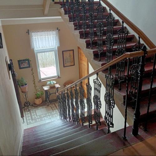 a spiral staircase in a house with a window at Villa Rosenberg in Mariánské Lázně