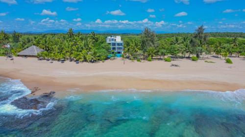 an aerial view of a beach with a hotel in the background at Marakolliya Beach Resort in Tangalle