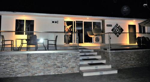 a house with stairs and a table and chairs at La Romantica in Contadora