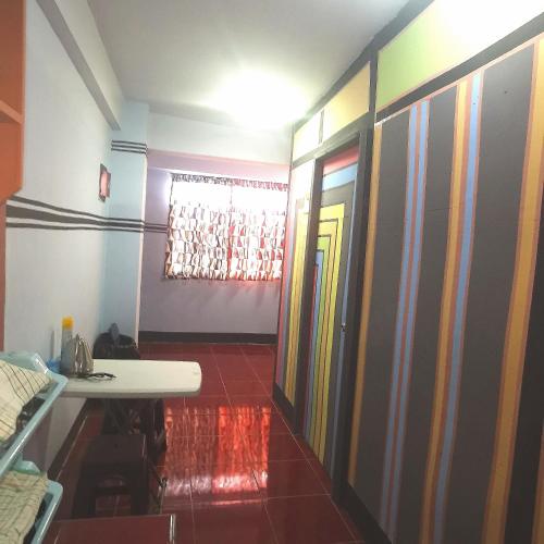 a hallway with a room with colorful walls at Cabanatuan City PNY TRANSIENT INN 4 in Cabanatuan