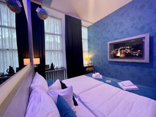 a bedroom with two beds and a tv on the wall at Smart Hotel Budapest in Budapest