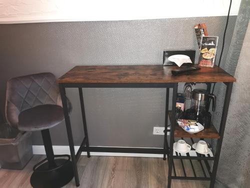 a wooden table with a chair next to a desk at Pension Zur Alten Post in Havelberg