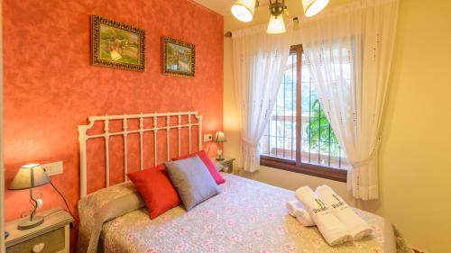 a bedroom with a bed and a window at Villa La Cola Nerja by Ruralidays in Nerja