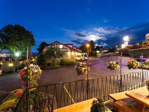 a view of a street at night with flowers at Village Family Motor Inn in Launceston