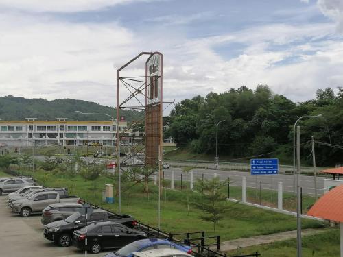 a parking lot with cars parked next to a highway at ezzahrahsyariahhomestay in Sandakan