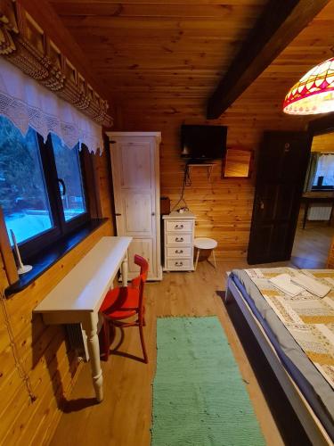a room with a desk and a bed in a cabin at Chata Starych Znajomych in Sanok