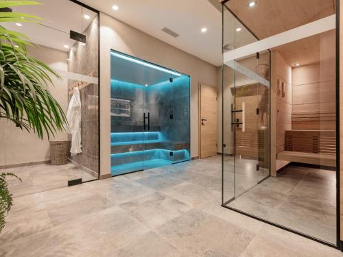 a bathroom with a shower and a glass door at MYALPS Ötztal in Umhausen