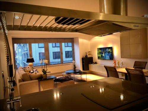 a living room with a couch and a table at Appartement Sunny home Deluxe in Knokke-Heist