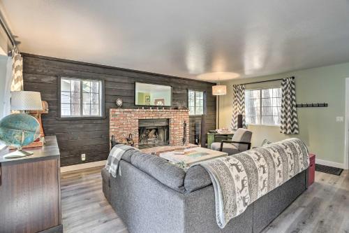 a living room with a couch and a fireplace at Cozy Cabin about 3 Mi to Lake Arrowhead Village! in Lake Arrowhead