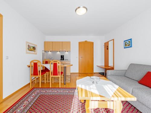 a living room with a couch and a table at Landhotel Gabriele in Unterwössen