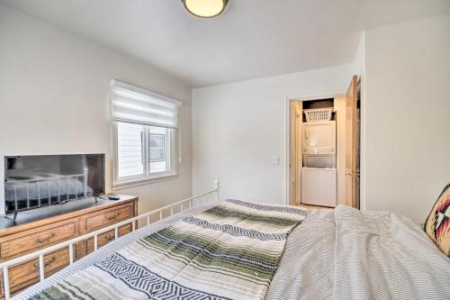 a bedroom with a bed and a television and a window at Beautiful Thermopolis Home with Private Yard and Grill in Thermopolis