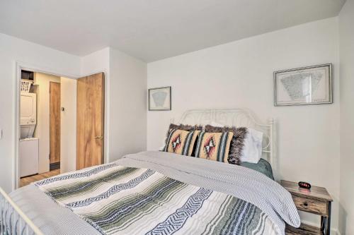 a bedroom with a bed with a blanket on it at Beautiful Thermopolis Home with Private Yard and Grill in Thermopolis