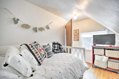 a bedroom with a bed with pillows and a tv at Beautiful Thermopolis Home with Private Yard and Grill in Thermopolis
