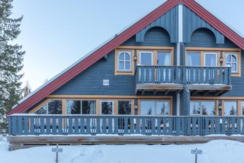 a log home with a large deck in the snow at Bakkebyvegen 22B in Trysil